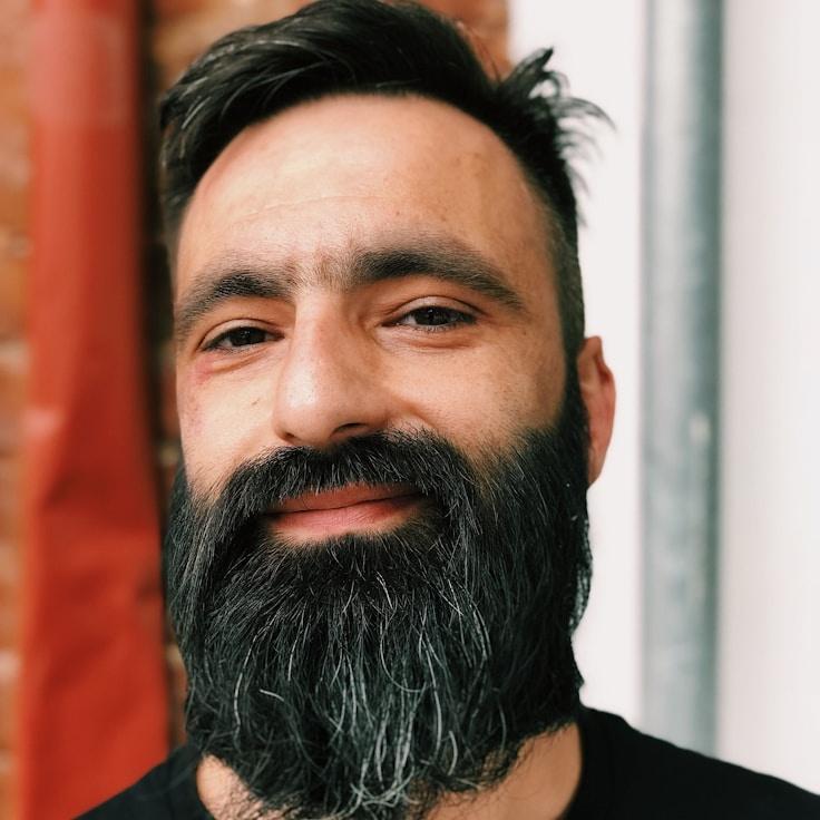 Asha Desai, Lead Design Curator at Modern Life Balance Hub, reviewing corporate floral arrangements